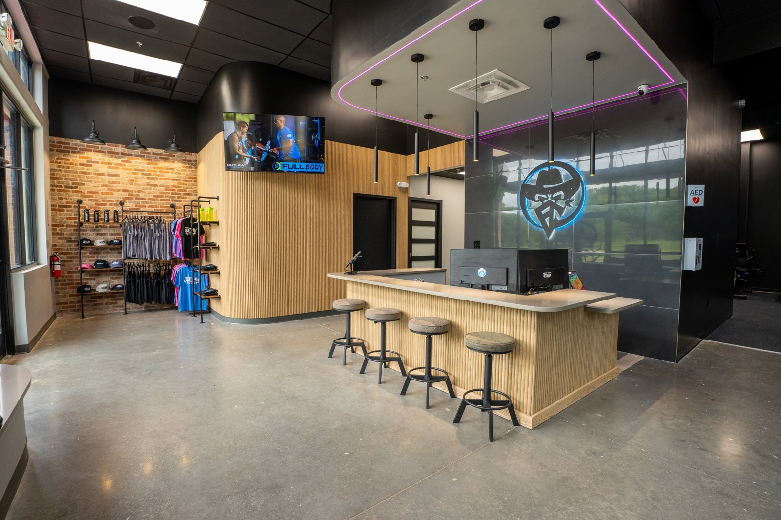 Supplied studio photograph of the reception desk and illuminated Outlaw logo